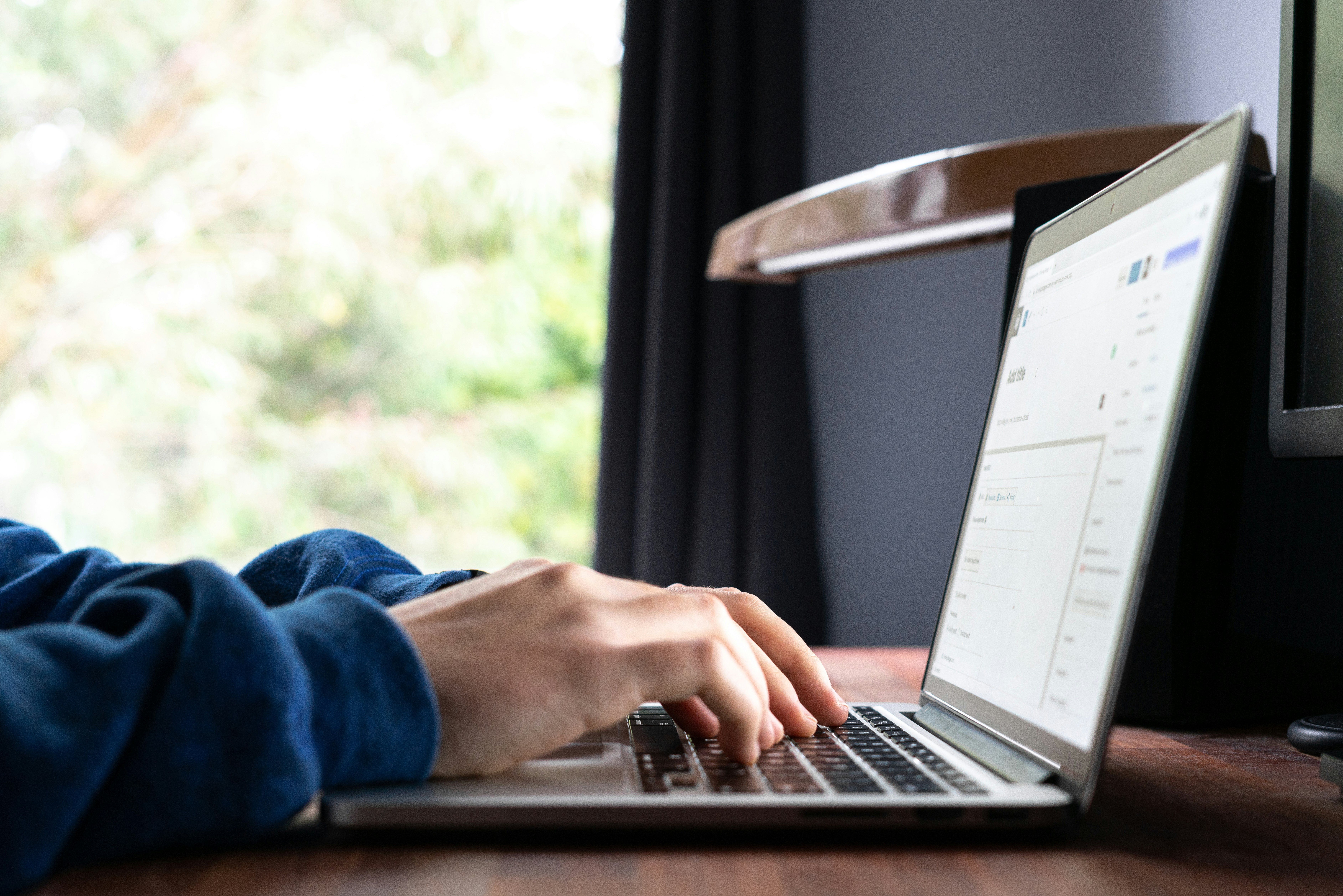 person using macbook pro on table